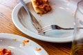 Dirty messy plates after pizza eating with unclean used utensils in the cafe.