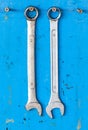 2 Dirty metallic wrench hanging with the grunge blue backg