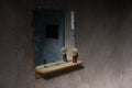 Dirty mirror in empty dark jail cell Royalty Free Stock Photo