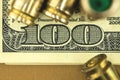 Dirty money concept background with dollars and bullets, close-up view Royalty Free Stock Photo