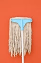 Dirty mop on brown wall Royalty Free Stock Photo