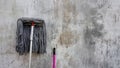 Dirty mop on wall background