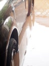 Dirty muddy dirt and toxic water flood after heavy rain in urban zone destroy a family car Royalty Free Stock Photo