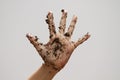 Dirty muddy hand on white