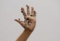 Dirty muddy hand on white