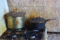 Dirty neglected gas stove with two old dirty pots Royalty Free Stock Photo