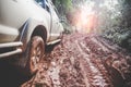 Dirty offroad car, SUV covered with mud on countryside road, Off-road tires, offroad travel and driving concept