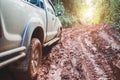 Dirty offroad car, SUV covered with mud on countryside road, Off-road tires,  offroad travel  and driving concept Royalty Free Stock Photo