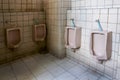 Dirty old bathroom,Interior Public toilet urinals in men toilet bowl is not very clean Royalty Free Stock Photo