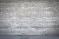 Dirty old grungy looking cement brick wall with a pathway running in front of it