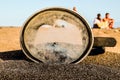 A dirty old lens is sitting on the sand Royalty Free Stock Photo