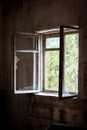 Dirty old open window with broken glass in abandoned house in ghost town Pripyat, Chernobyl Exclusion Zone, Ukraine Royalty Free Stock Photo