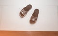 Dirty old rubber flip-flops standing on laminate floor in the apartment. Maintenance repair works renovation in the flat. Royalty Free Stock Photo