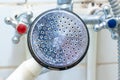 Dirty old shower head close up with limescale and calcified, rusty shower mixer and mould tiles on background, cleaning bathroom Royalty Free Stock Photo