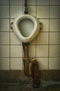 Dirty old soviet urinal in public toilet Royalty Free Stock Photo