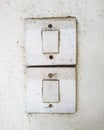 Dirty old switches on the white wall Royalty Free Stock Photo