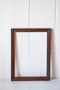 Dirty old vintage picture frame on the wall. White interior room Royalty Free Stock Photo