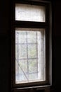 Dirty old window with bars in abandoned house in ghost town Pripyat, Chernobyl Exclusion Zone, Ukraine. Vertical photo Royalty Free Stock Photo
