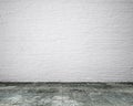 Dirty old wooden floor with white bricks wall, background Royalty Free Stock Photo