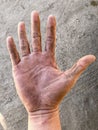 Dirty palm of Asian worker man`s right hand. Skin creases are obvious