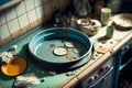 dirty plates and towel in big blue basin standing in dirty sink is kitchen mess