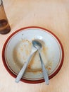 Dirty plates with used food, spoons and forks, and remaining drinking water. Royalty Free Stock Photo