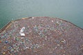 Garbages floating on the water of an accumulation lake.