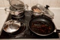Dirty pots and pans are placed on a stainless steel electric stove on the galley on the ship