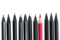 Dirty red pencil and black pencils on white background Royalty Free Stock Photo