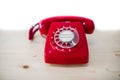 Dirty red vintage phone on pine wooden table.. Royalty Free Stock Photo