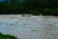 Dirty river current after rain. Mudslide concept. River flow with dirty water after heawy rain Royalty Free Stock Photo