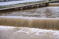 Dirty river current after rain. Mudslide concept. River flow with dirty water after heawy rain. Royalty Free Stock Photo