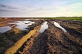 Dirty road with mud and puddles