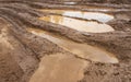 Dirty road. puddle with havy tires track Royalty Free Stock Photo