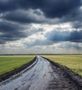 Dirty road to horizon and dramatic sky Royalty Free Stock Photo