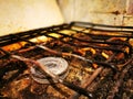 Dirty and rusty top of a kitchen gas stove with pieces of debris, food and burning, dirt stains, used for cooking Royalty Free Stock Photo