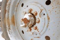 Dirty and rusty tractor wheel closeup in winter snow Royalty Free Stock Photo