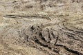 Dirty rutted road with pits and puddles in the spring.