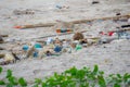 Dirty sand beach with various garbages Royalty Free Stock Photo