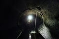 Dirty sewage water flowing through drainage round sewer tunnel pipe Royalty Free Stock Photo