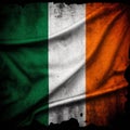 Dirty shabby Irish flag. Crumpled Ireland flag isolated on black background