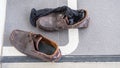 Dirty shoes and black socks on the floor in the office. Royalty Free Stock Photo