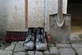 Dirty shoes, a shovel and a push broom Royalty Free Stock Photo