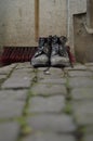 Dirty shoes, a shovel and a push broom Royalty Free Stock Photo