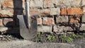 Dirty shovel on brick wall background Royalty Free Stock Photo