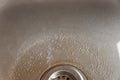 Dirty sink drain with leftover food. Stainless steel sink