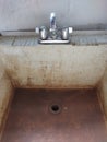 Dirty Slop Sink with Shiny Polished Chrome Faucet