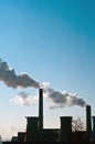 Dirty smoke on the sky from the pipes of the factory. Industrial chimneys air pollution Royalty Free Stock Photo