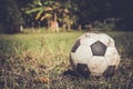 Dirty soccer ball on grass