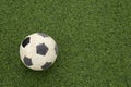 Dirty soccer ball on green football field, top view. Space for text Royalty Free Stock Photo